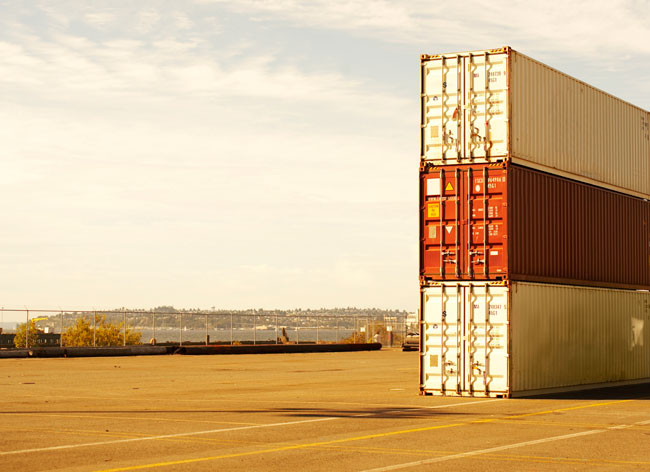 three shipping containers in a dock